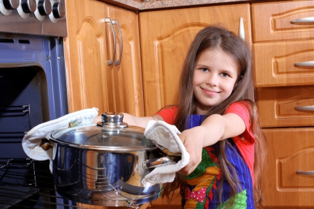 girl cooking dinner in the kitchenの写真素材