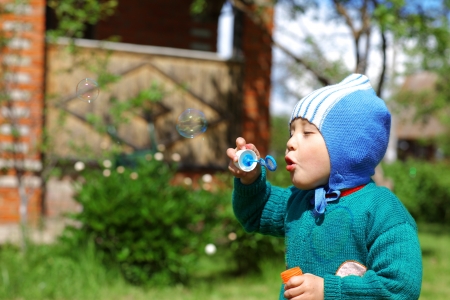 Child plays with bubbles の写真素材