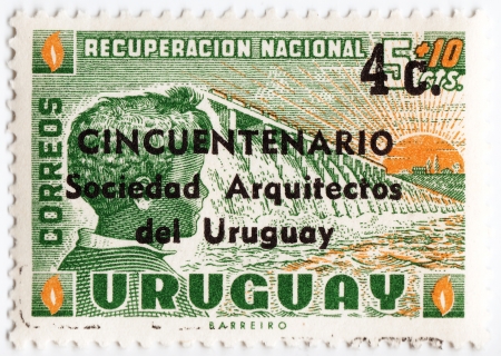 URUGUAY - CIRCA 1953 : stamp printed in Uruguay with happy man and rising sun, circa 1953のeditorial素材