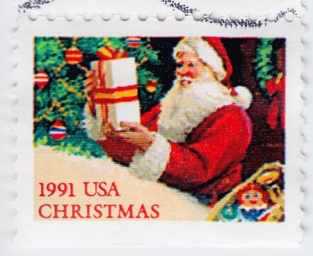 USA - CIRCA 1991 : stamp printed in USA shows Santa with gift, circa 1991の写真素材