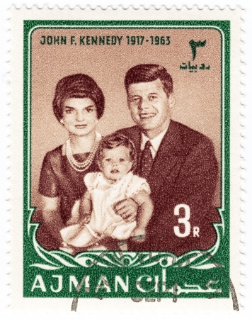 AJMAN - CIRCA 1965   stamp printed in Ajman show John F Kennedy  R , her wife  Jacqueline and daughter Caroline, circa 1965のeditorial素材