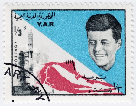YAR - CIRCA 1970 : Stamp printed in YAR shows John F Kennedy background usa flag and spaceshuttle , circa 1970のeditorial素材