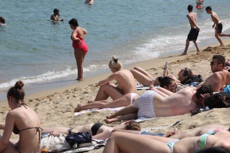 BARCELONA - JUNE 11: Crowded beach with tourists and locals in summer on June 11, 2013 in Barcelona, Spain. Barcelona is a famous destination for hundred of thousands of tourists a yearのeditorial素材