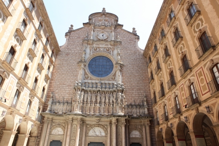 facade of the basilica at the Benedictine Abbey at Montserrat, Santa Maria de Montserrat, near Barcelona, Catalonia, Spain の写真素材