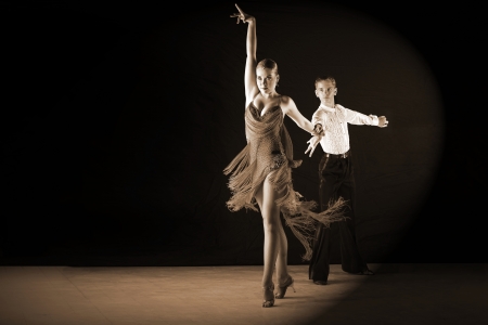dancers in ballroom against black backgroundの写真素材