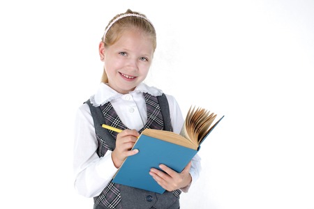 8 year old school girl with book and pen smiling on white background