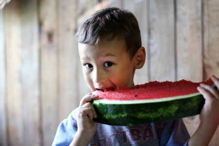 The boy with water-melonの写真素材