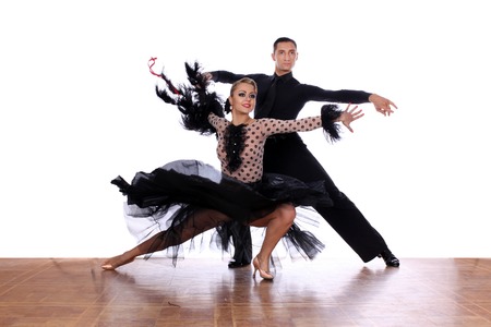 Latino dancers in ballroom against white backgroundの写真素材