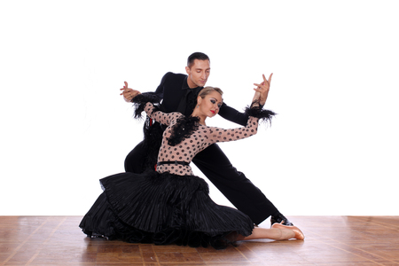 Latino dancers in ballroom against white backgroundの写真素材