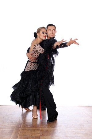 Latino dancers in ballroom against white backgroundの写真素材