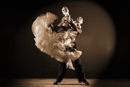 dancers in ballroom isolated on black backgroundの写真素材