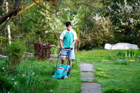 Man mowing the lawn with lawnmowerの写真素材