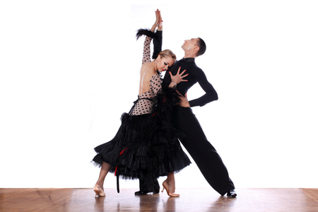 Latino dancers in ballroom against white backgroundの写真素材