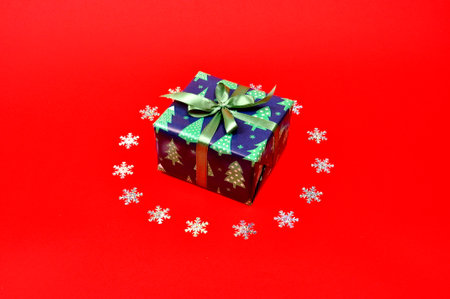 Gifts and snowflakes on red background.の写真素材