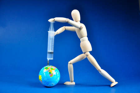 The vaccine with a syringe. The concept of protecting the globe, mass vaccinationの写真素材