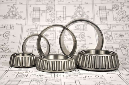 Roller bearings on the background of drawings. Spare parts.
