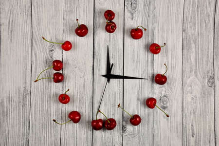 Creative concept photo. A watch with a cherry berry dial
