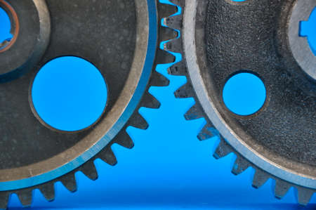 Gear wheels on a blue background. Spare parts,