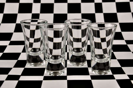 Shot glasses on a black and white background.の写真素材