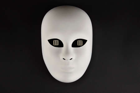 White theatrical mask and playing diceの写真素材