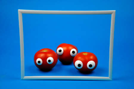 Red, ripe tomatoes in a frameの写真素材