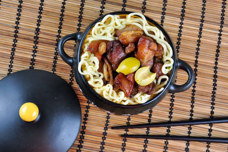 Roast pork in a black bowl.の写真素材