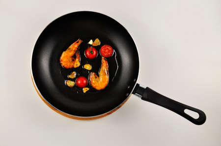 Shrimp with garlic and tomatoes. in a pan. seafood. On a white background.の写真素材