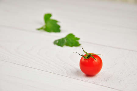 Red cherry tomatoes on a white background.の写真素材