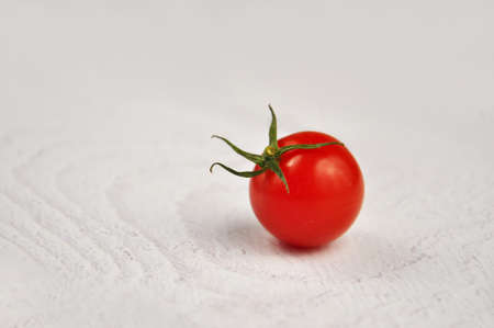 Red cherry tomatoes on a white background.