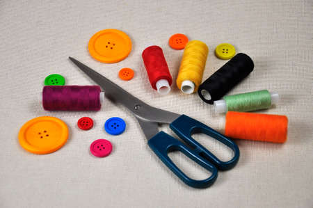 Multicolored thread spools and buttons for sewing clothes.