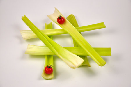 Fresh green Celery and cherry Tomatoes on white background. Food for healthy concept.の写真素材