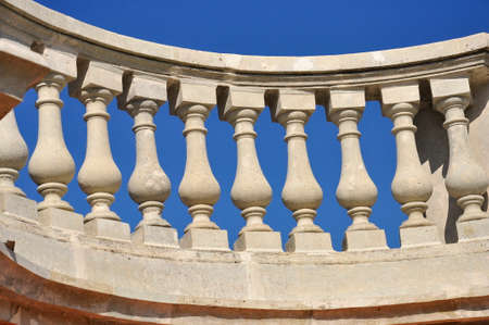 White railings with decorative balusters against a blue sky. architectural elements.の写真素材