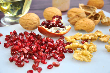 Pomegranate seeds and Walnuts on the kitchen table.の写真素材