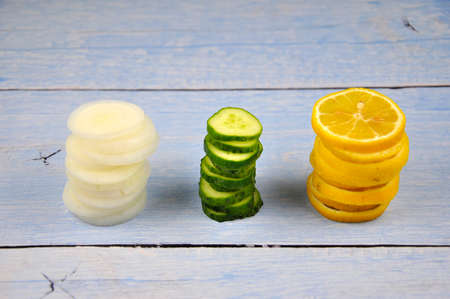 Cucumber, lemon and onion sliced on the table