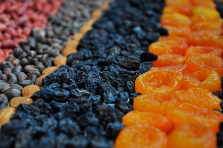 Dried fruits and Nuts on the table. Blurred background.の写真素材
