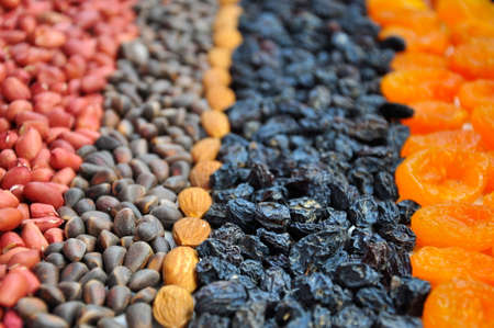 Dried fruits and Nuts on the table. Blurred background.の写真素材