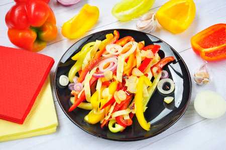 Salad of sweet bell peppers on a black plate.の写真素材