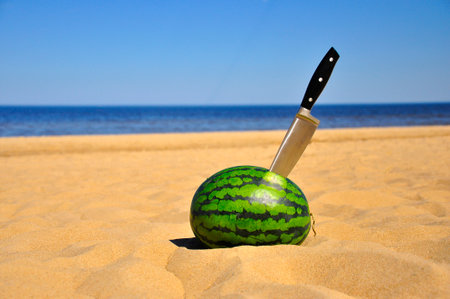 Ripe Watermelon and a knifeの写真素材