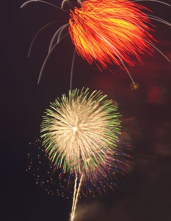 Multiple colourful fireworks explosions on black night sky.の写真素材