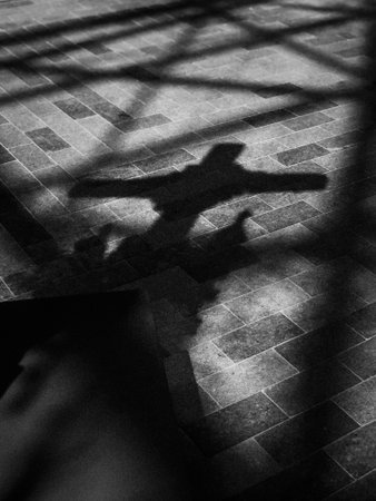 Shadow of a man lying on the floor. Black and white.の写真素材