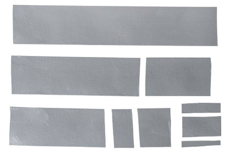 Assorted strips of woven carbon tape adhesive on transparent background. Multiple pieces of reinforced construction tape in various sizes isolated.の写真素材