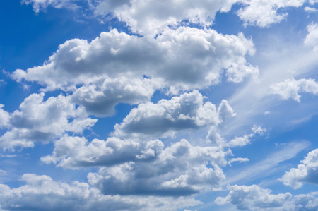Serene sky with fluffy clouds. Expansive blue sky with scattered cumulus clouds on a bright day.の写真素材