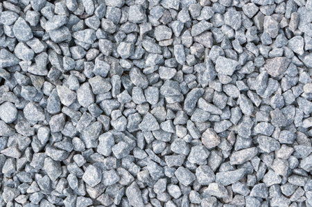 Close-up of a textured. Coarse gravel background. A durable building material. Made of gray. Crushed stone. Perfect for construction and landscaping projects.の写真素材