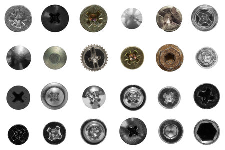 Top view of a neatly laid out collection of heads of screws, bolts and rivets of various shapes and sizes on a clear background.の写真素材