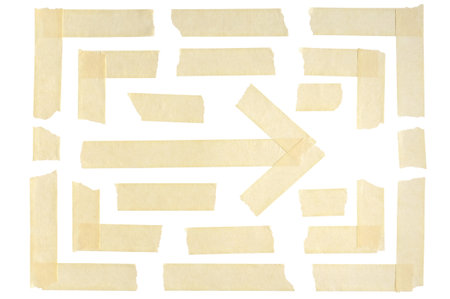 Tape and adhesive paper are arranged to form corners and arrow. Strips and pieces of wrinkled masking tape isolated on a white background.の写真素材