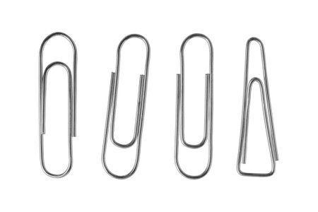 A collection of various paper clips arranged on a clean surface showing different shapes and sizes in an organized manner. Isolatedの写真素材