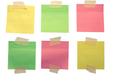 Six colorful sticky notes attached with adhesive tape create a vibrant and organized display on a clean white background. Isolatedの写真素材