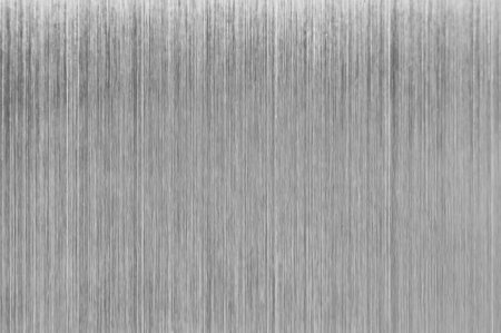 Brushed metal texture providing a sleek and modern industrial aesthetic, ideal for backgrounds and design elementsの写真素材