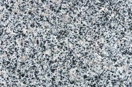 Black and white quartz stone surface texture. Close-up of artificial stone surface composed of quartz and marble chips for background or design use.の写真素材