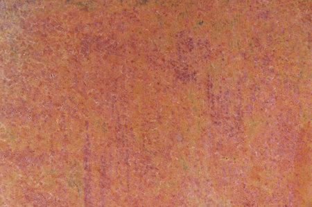 Close up view of a rusty iron sheet, highlighting the texture and color variations caused by corrosion and oxidation, suitable for backgrounds and texturesの写真素材